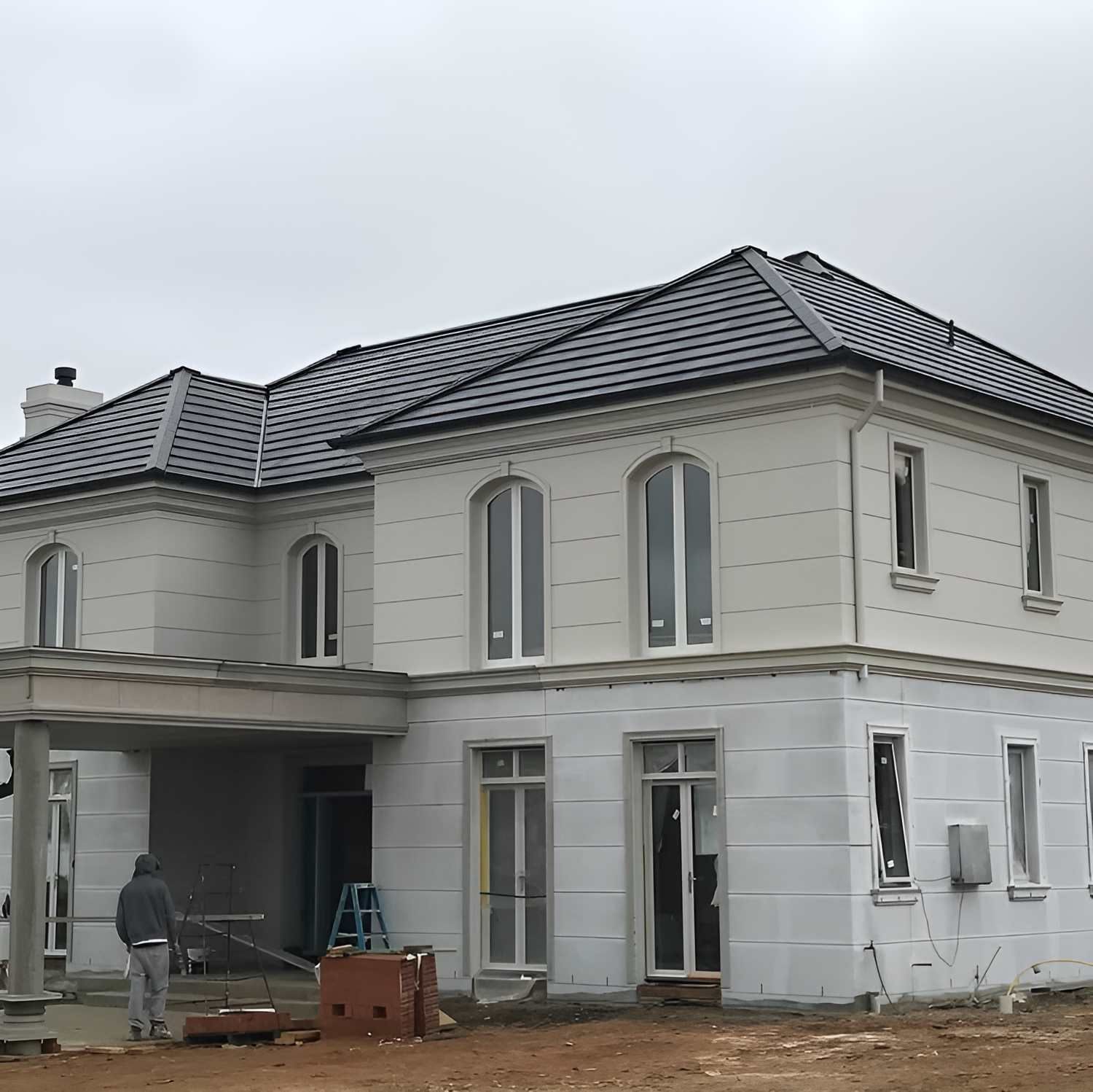 A Large White House With A Tiled Roof Is Under Construction — Lance Ward Roof Tiling in Orange, NSW