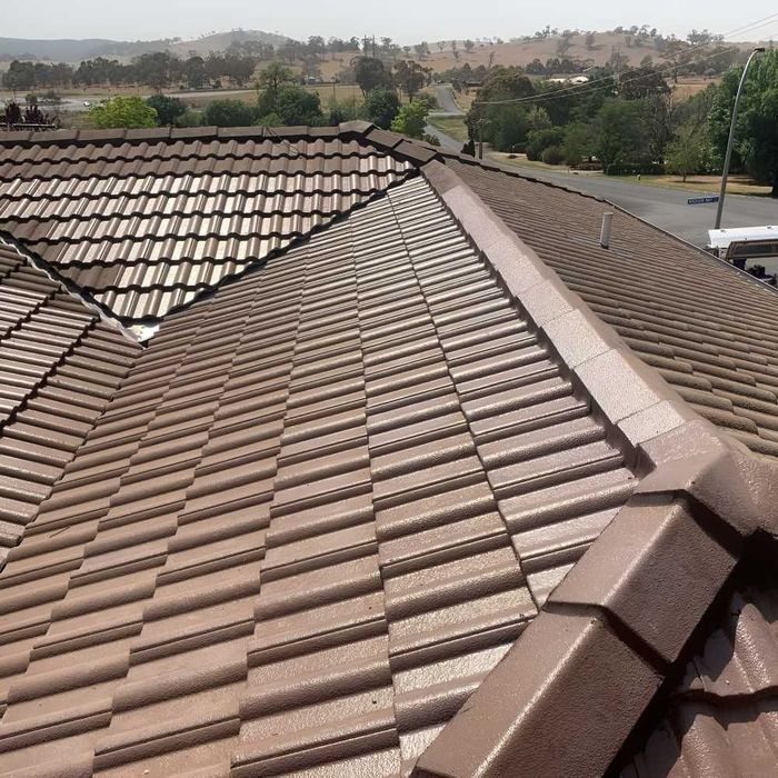 A Brown Tiled Roof With A Valley In The Background — Lance Ward Roof Tiling in Orange, NSW