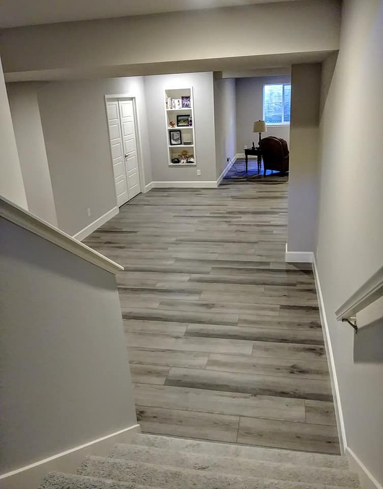A hallway with stairs leading up to a living room.