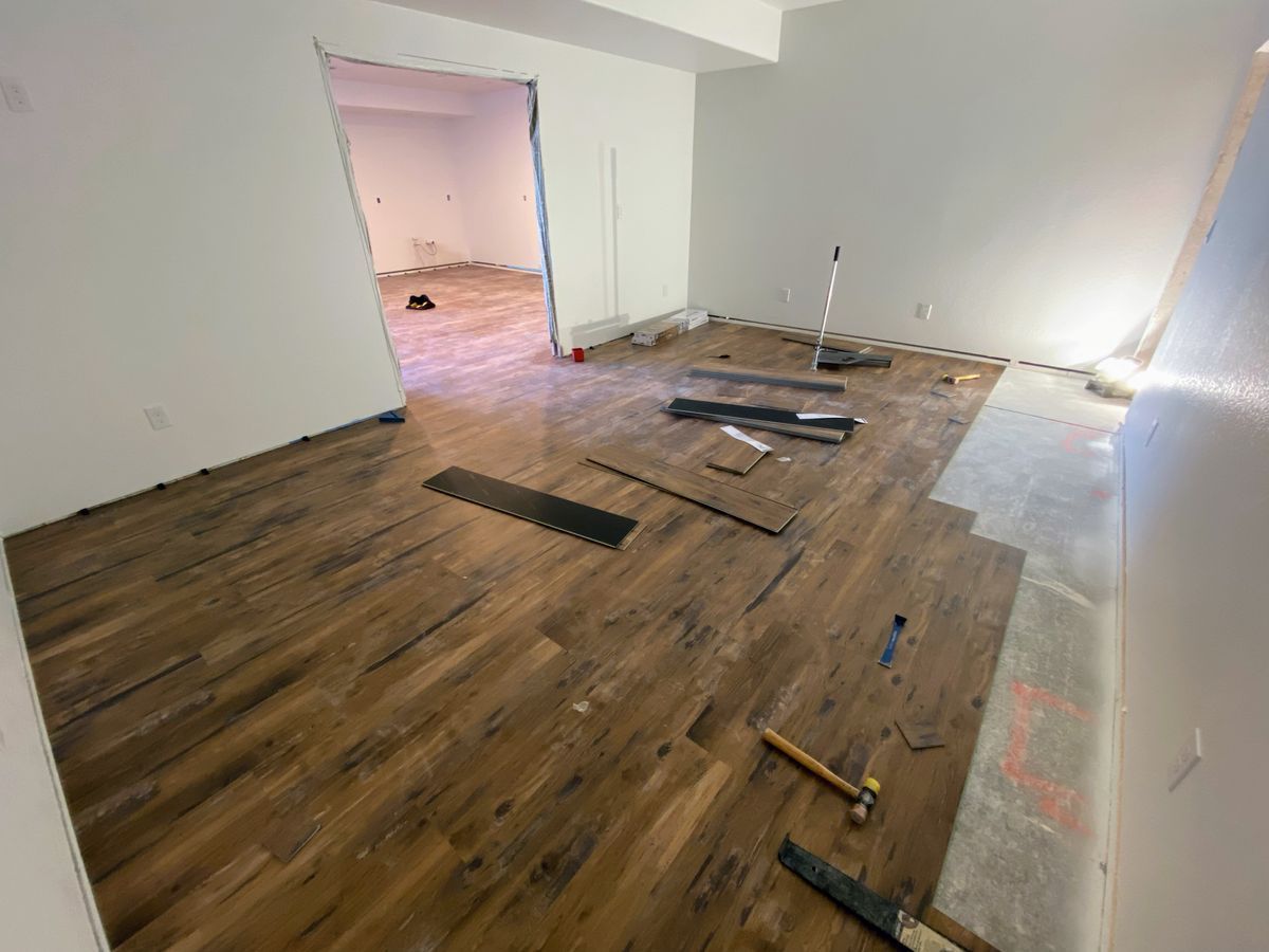 A room with a wooden floor and a lot of tools on the floor.