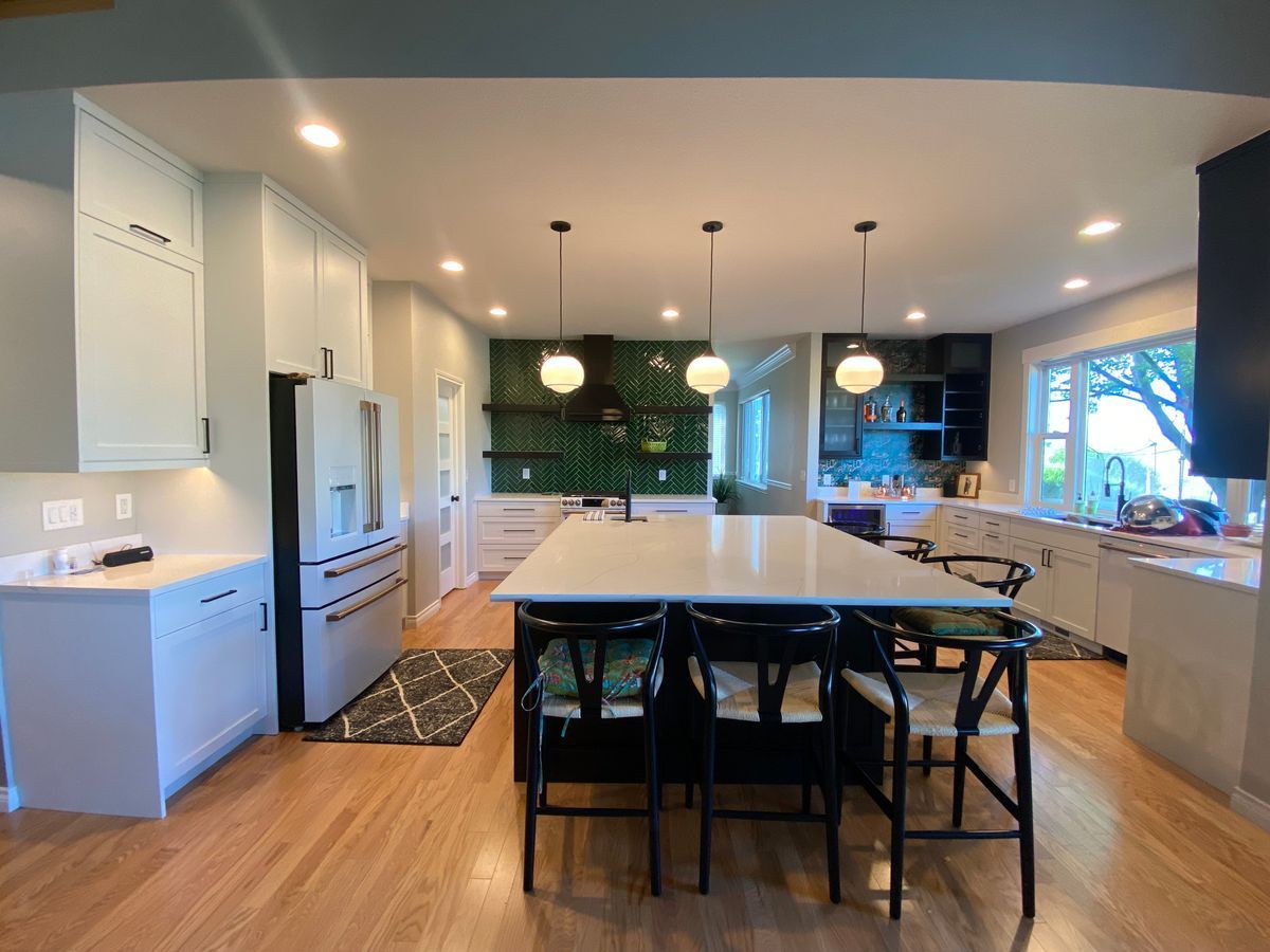 A kitchen with a large island and stools