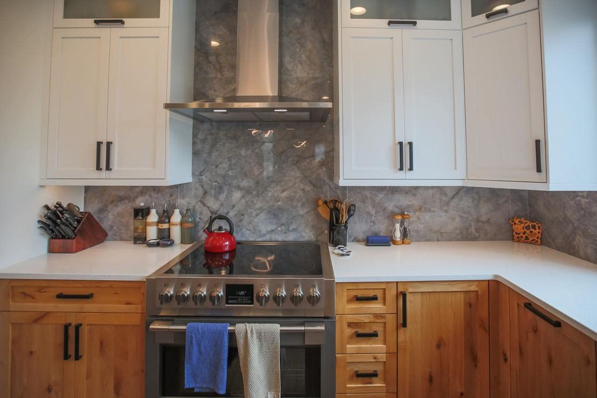 A kitchen with stainless steel appliances and wooden cabinets.