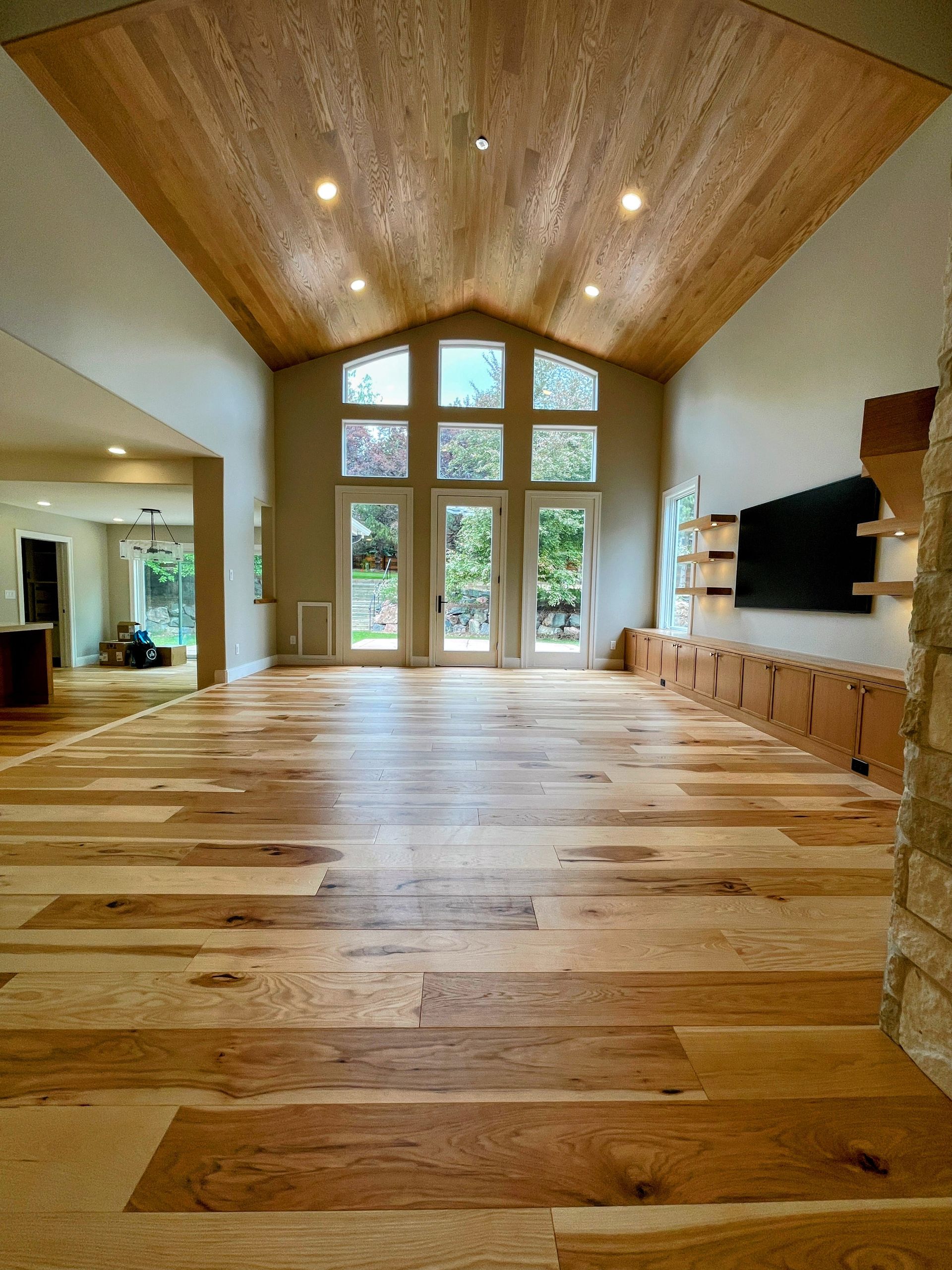 A large room with wooden floors and a vaulted ceiling