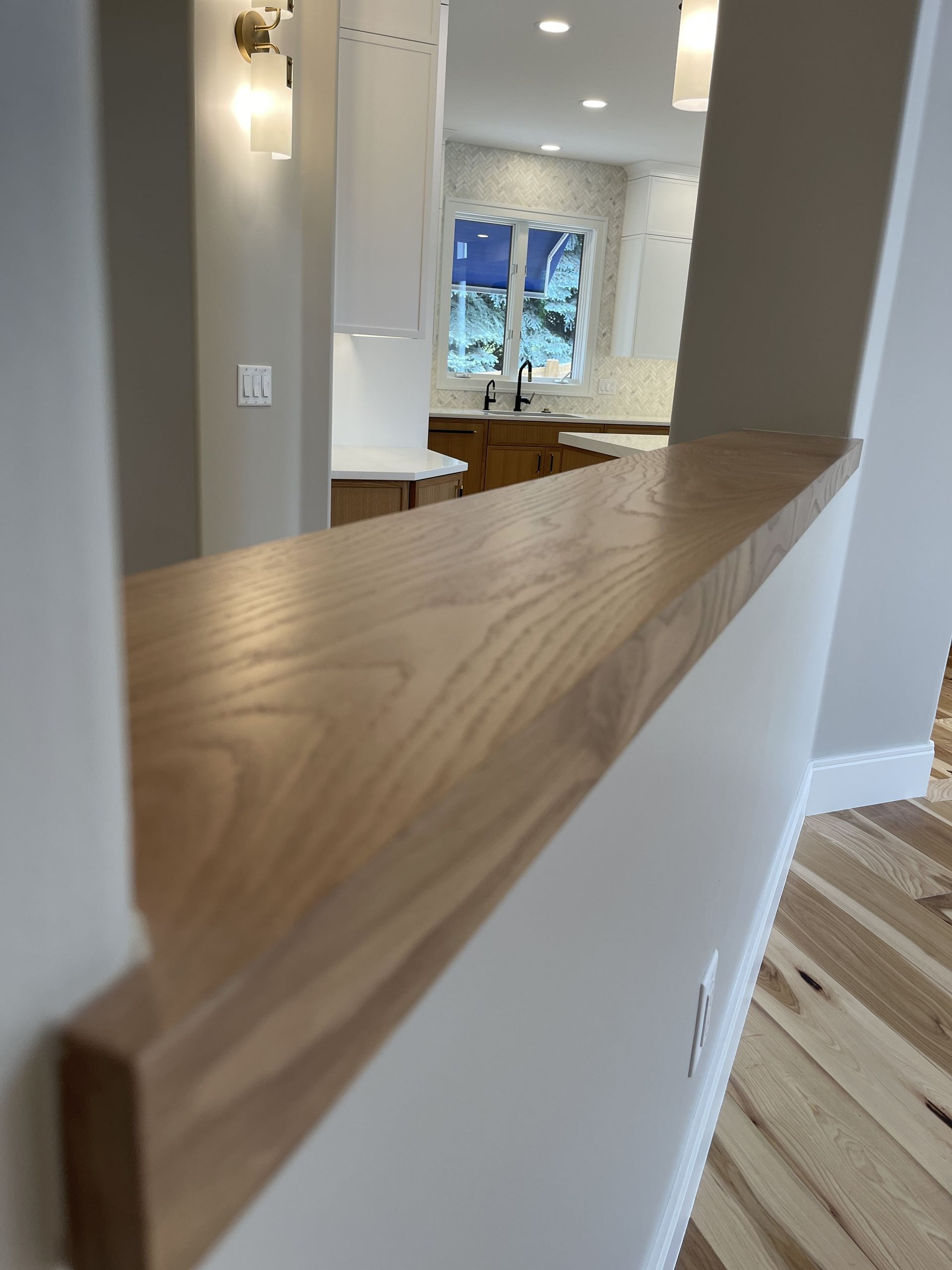 A kitchen with a wooden counter top and a window.