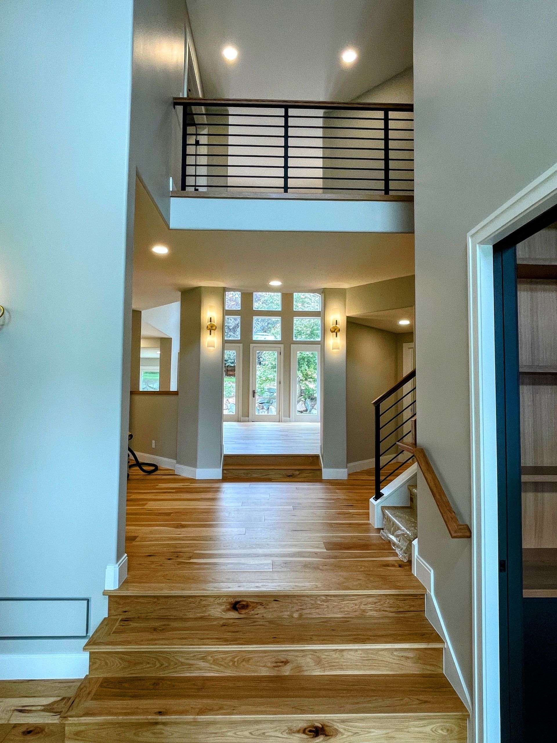 A hallway with stairs leading up to the second floor of a house