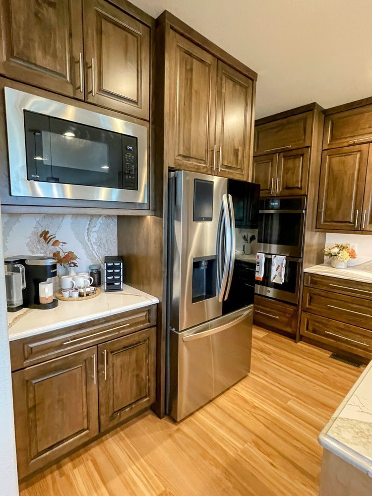 A kitchen with stainless steel appliances and wooden cabinets.