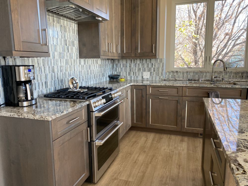 A kitchen with stainless steel appliances and wooden cabinets.