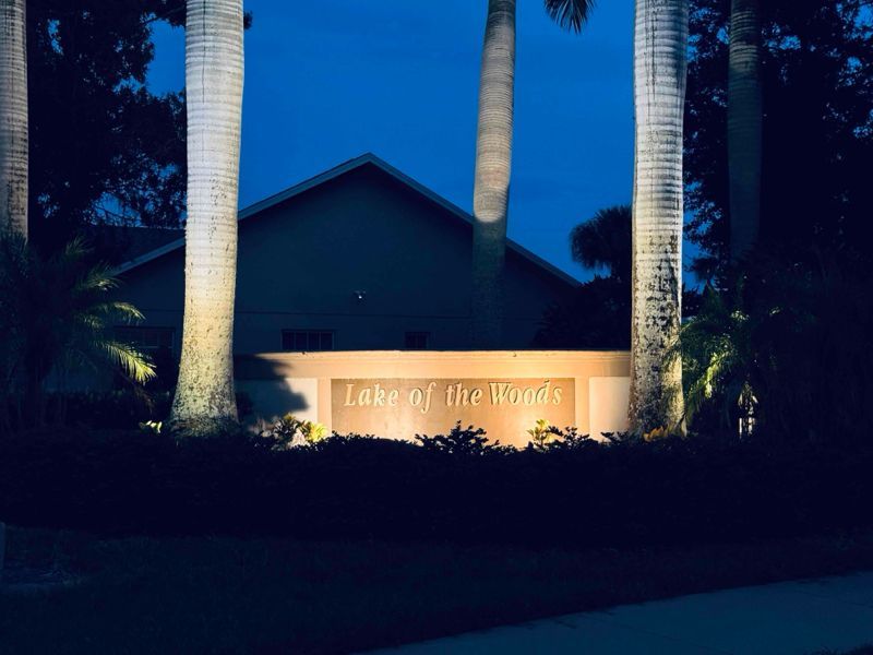 A twilight shot of an illuminated sign reading 