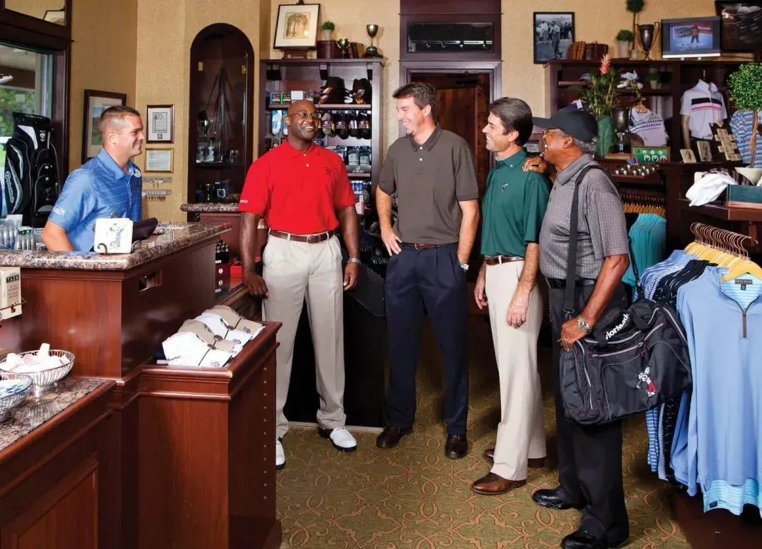 A group of men are standing in a store talking to each other