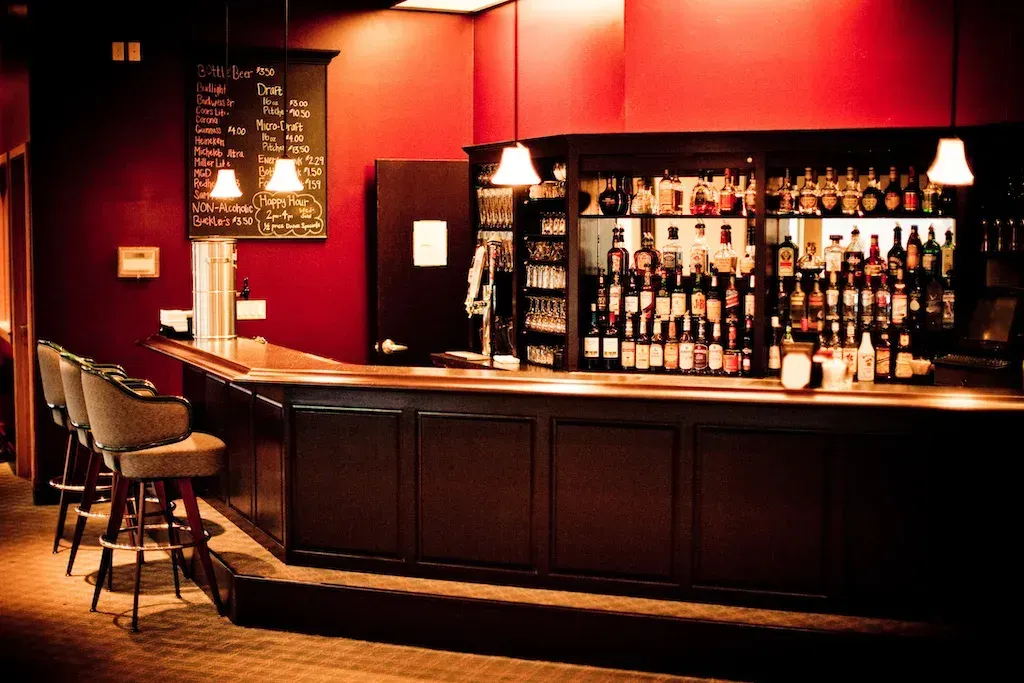A bar with a lot of bottles on it