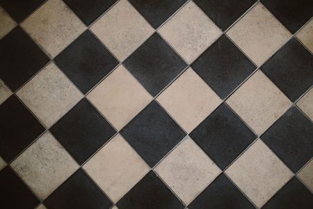 Black and white diamond-patterned tiled floor or wall texture