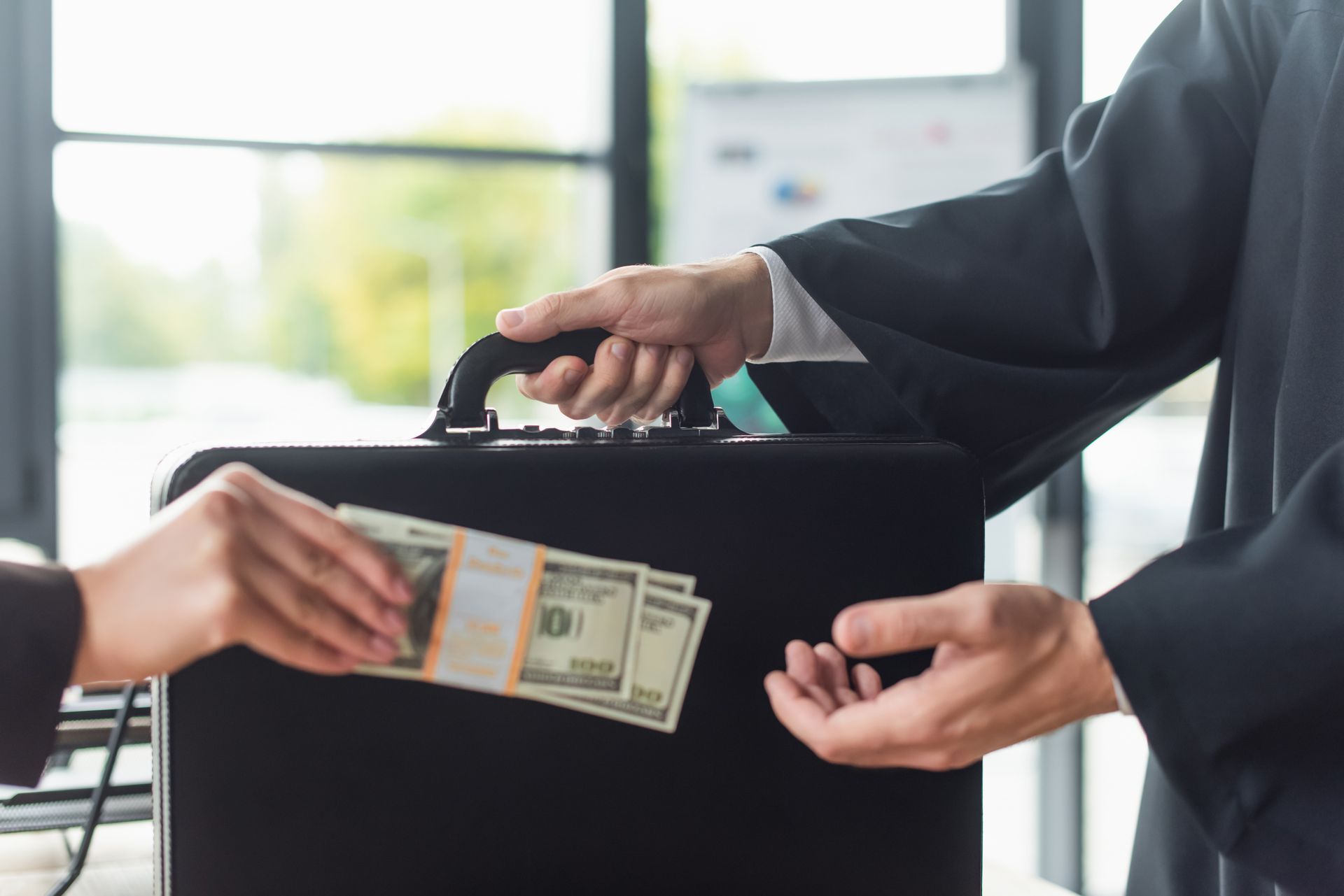 woman handing over money to a man