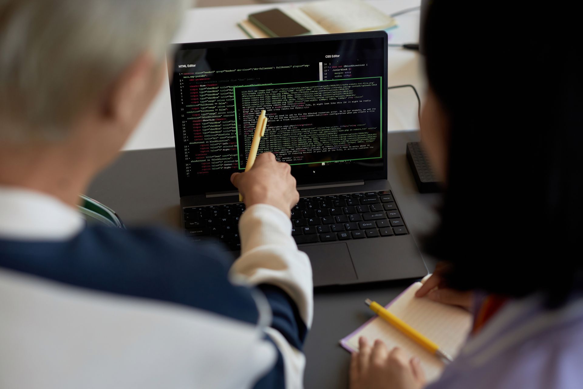 guy with a pen pointing at codes