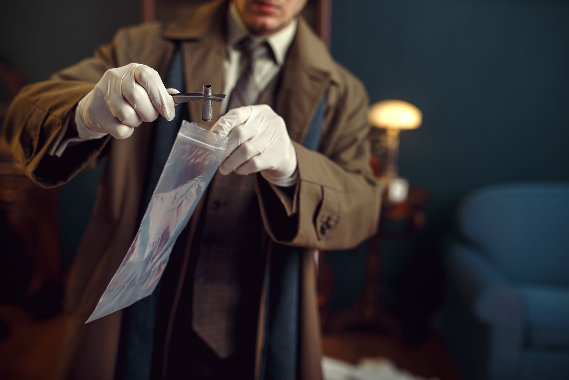 male detective with tweezers