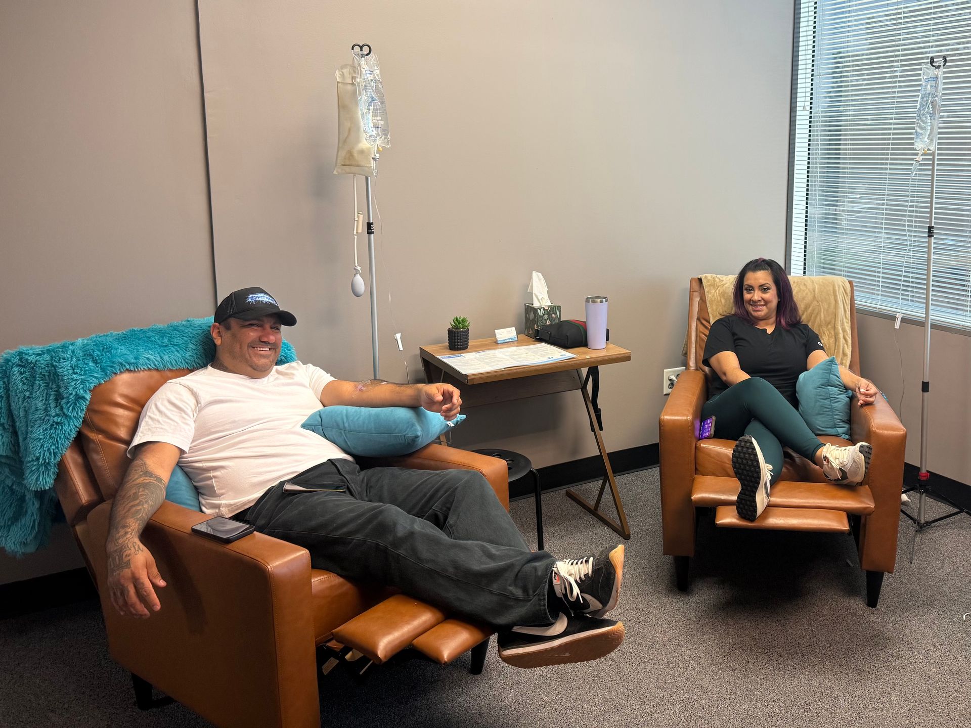 Couple smiling while receiving B12 and NAD+ IV therapy at Bounce Hydration in Houston