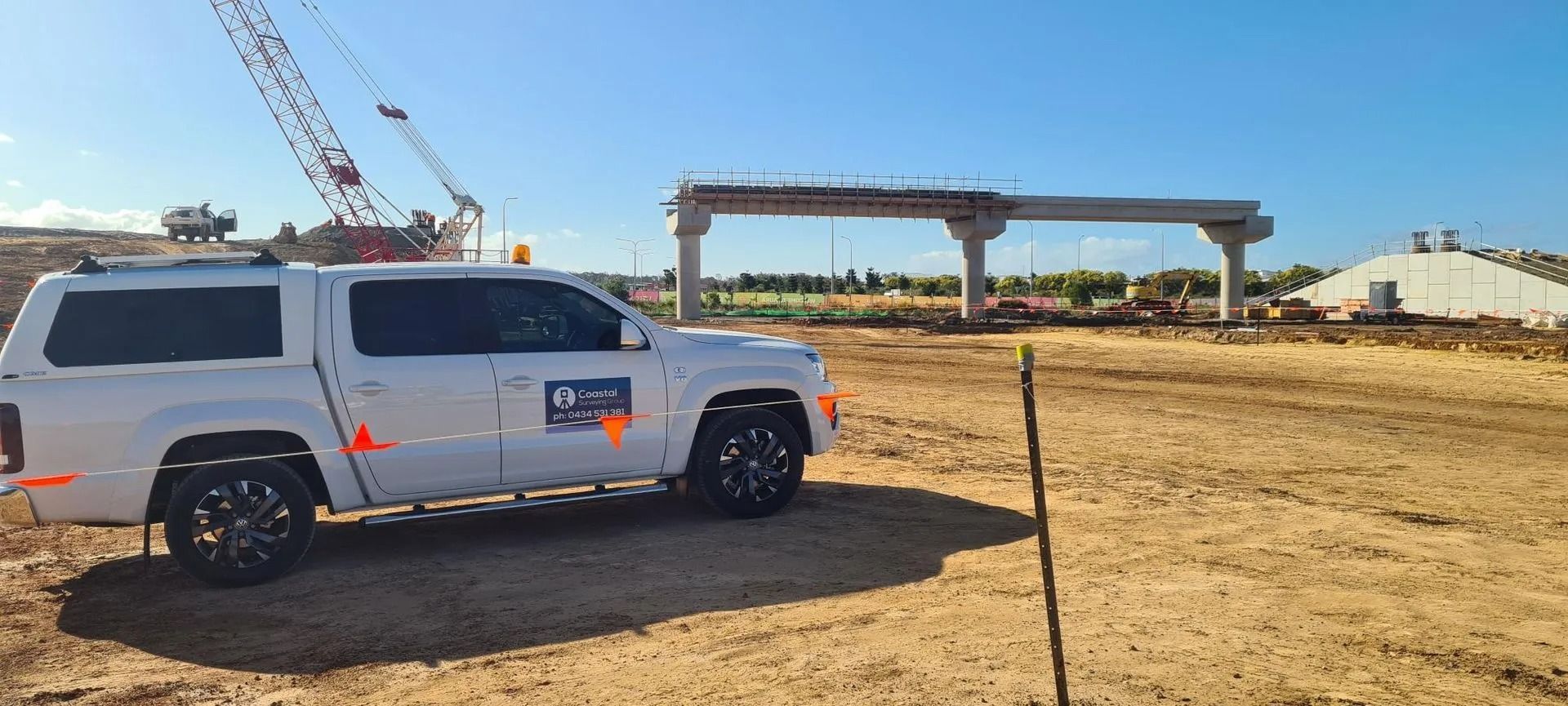White SUV Parked at a Construction Site With Cranes — Coastal Surveying Group Pty Ltd In Baringa, QLD