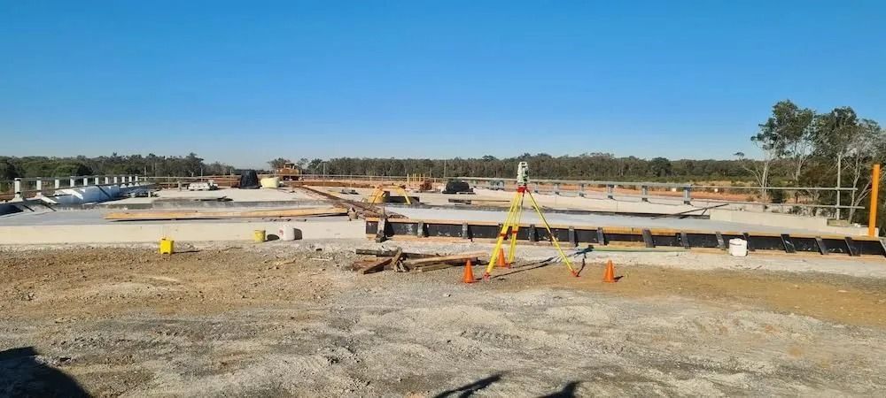 Construction Site With Concrete Slabs, Orange Cones, Equipment, and Workers — Coastal Surveying Group Pty Ltd In Baringa, QLD