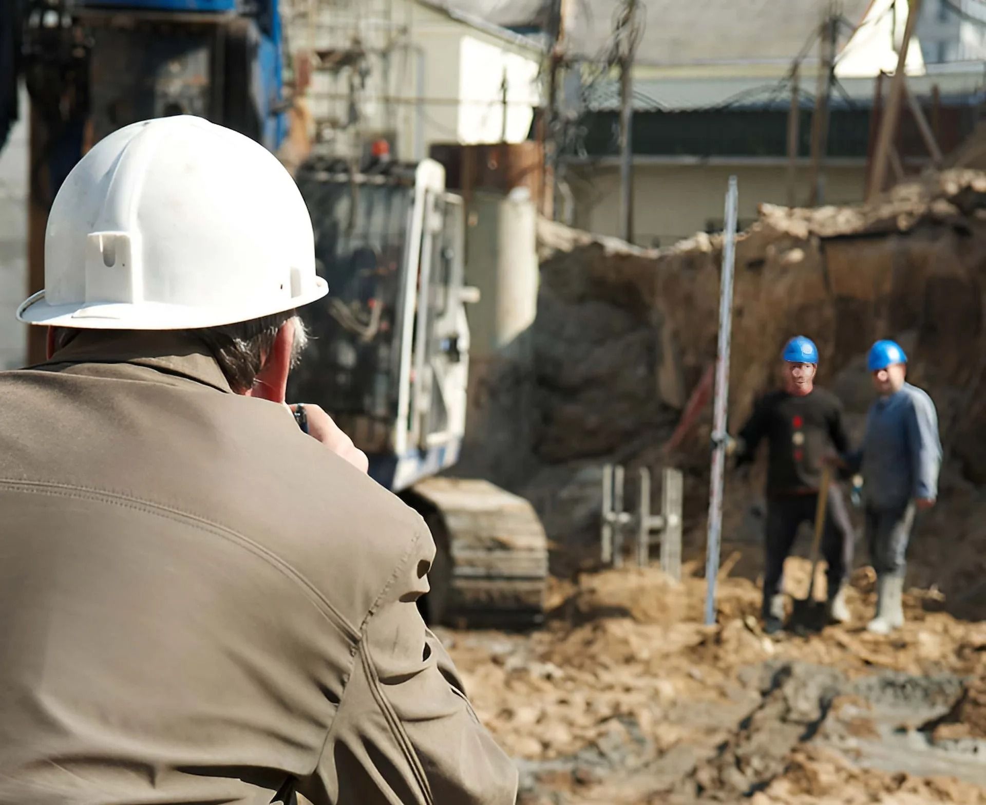Construction Worker in White Hard Hat Photographing Two Workers — Coastal Surveying Group Pty Ltd In Baringa, QLD