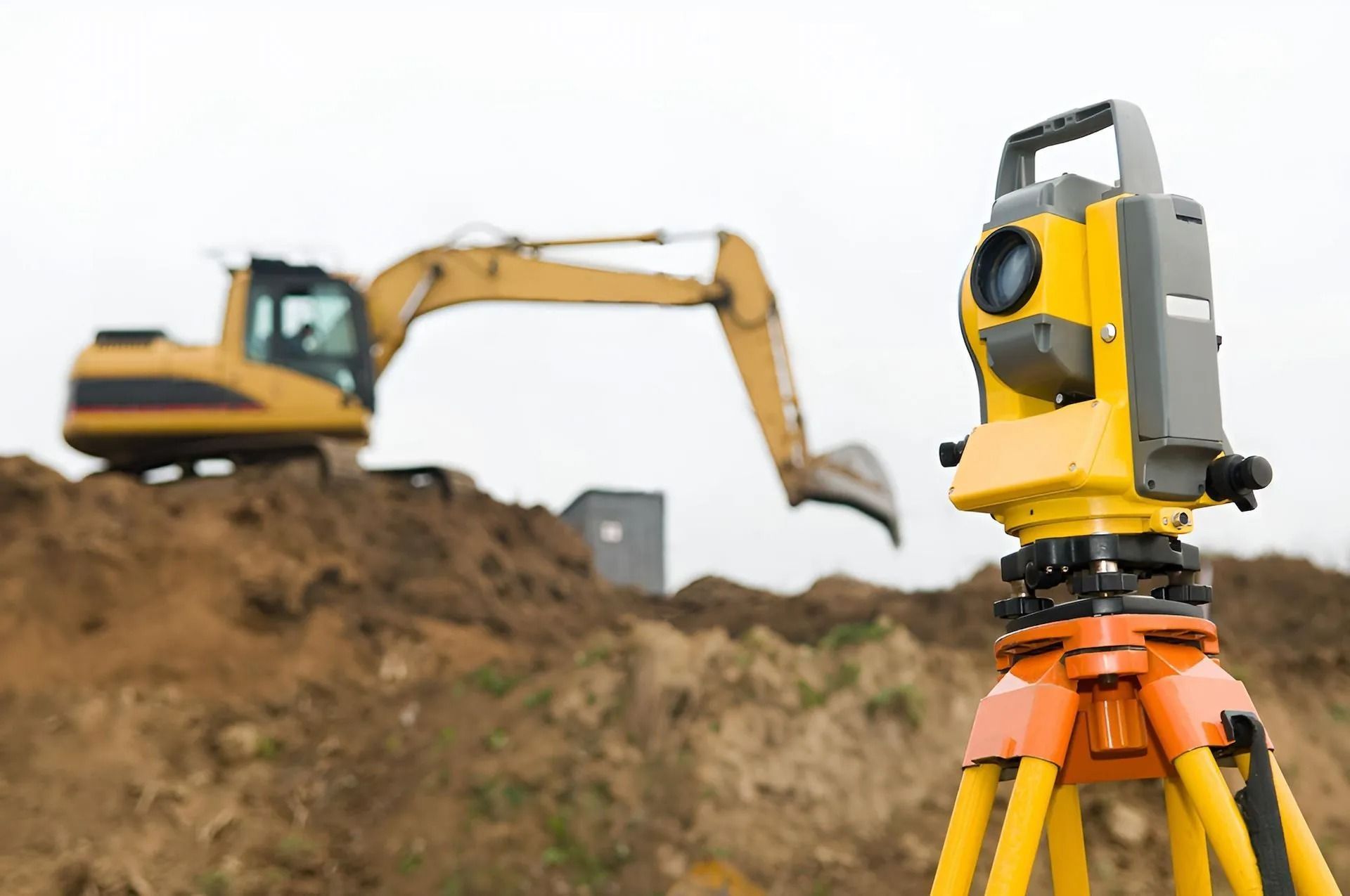 Yellow Surveying Instrument on Tripod in Foreground — Coastal Surveying Group Pty Ltd In Baringa, QLD