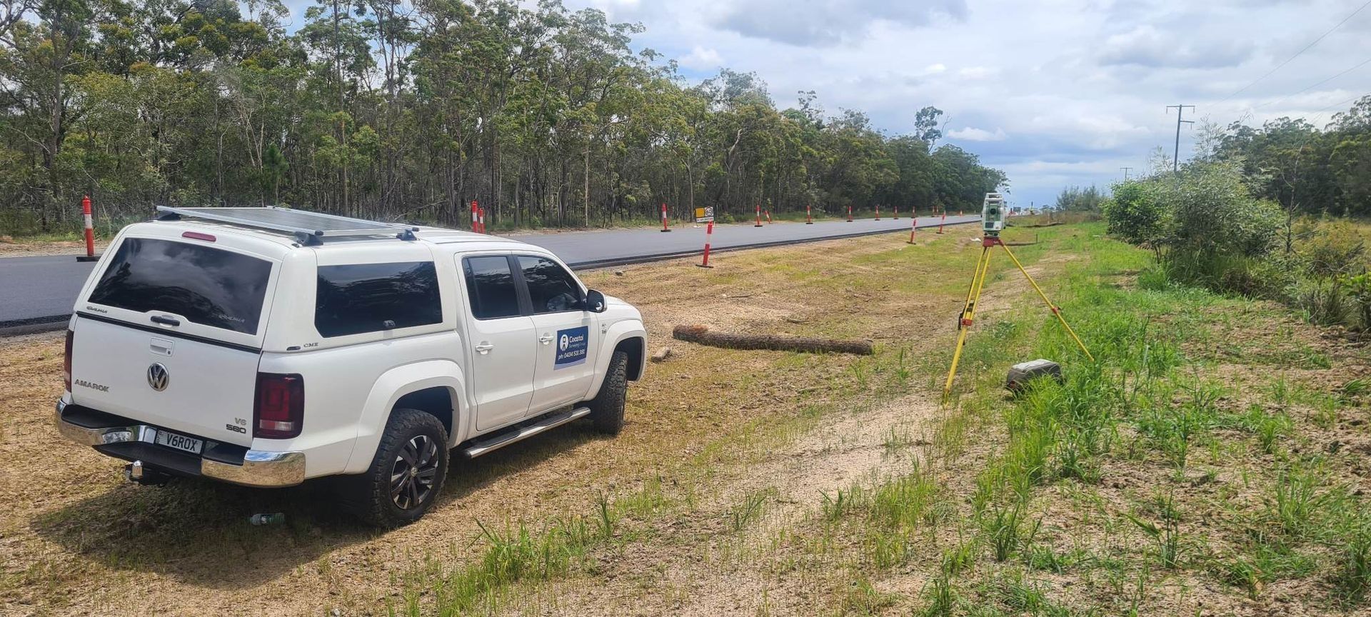 White Police SUV Parked on a Grassy Roadside Beside a Paved Road — Coastal Surveying Group Pty Ltd In Baringa, QLD
