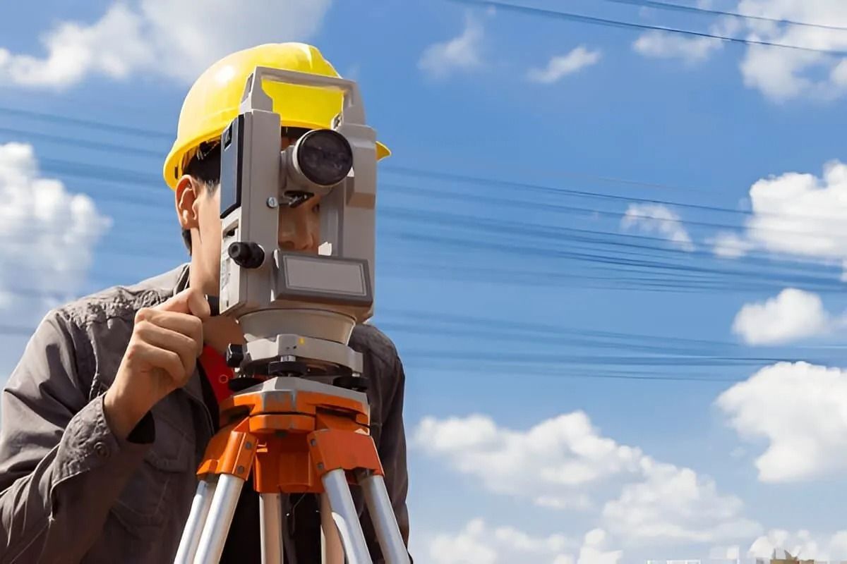 Surveyor Using a Tripod-mounted Theodolite Outdoors — Coastal Surveying Group Pty Ltd In Moreton Bay, QLD