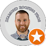Man smiling in a circular profile badge with a gold star icon on the lower right