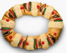 A wreath made of bread and vegetables on a white background.