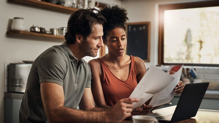 Couple Looking At Papers — Charlotte, NC — Next Wave Tax Services Couple Looking At Papers — Charlotte, NC — Next Wave Tax Services
