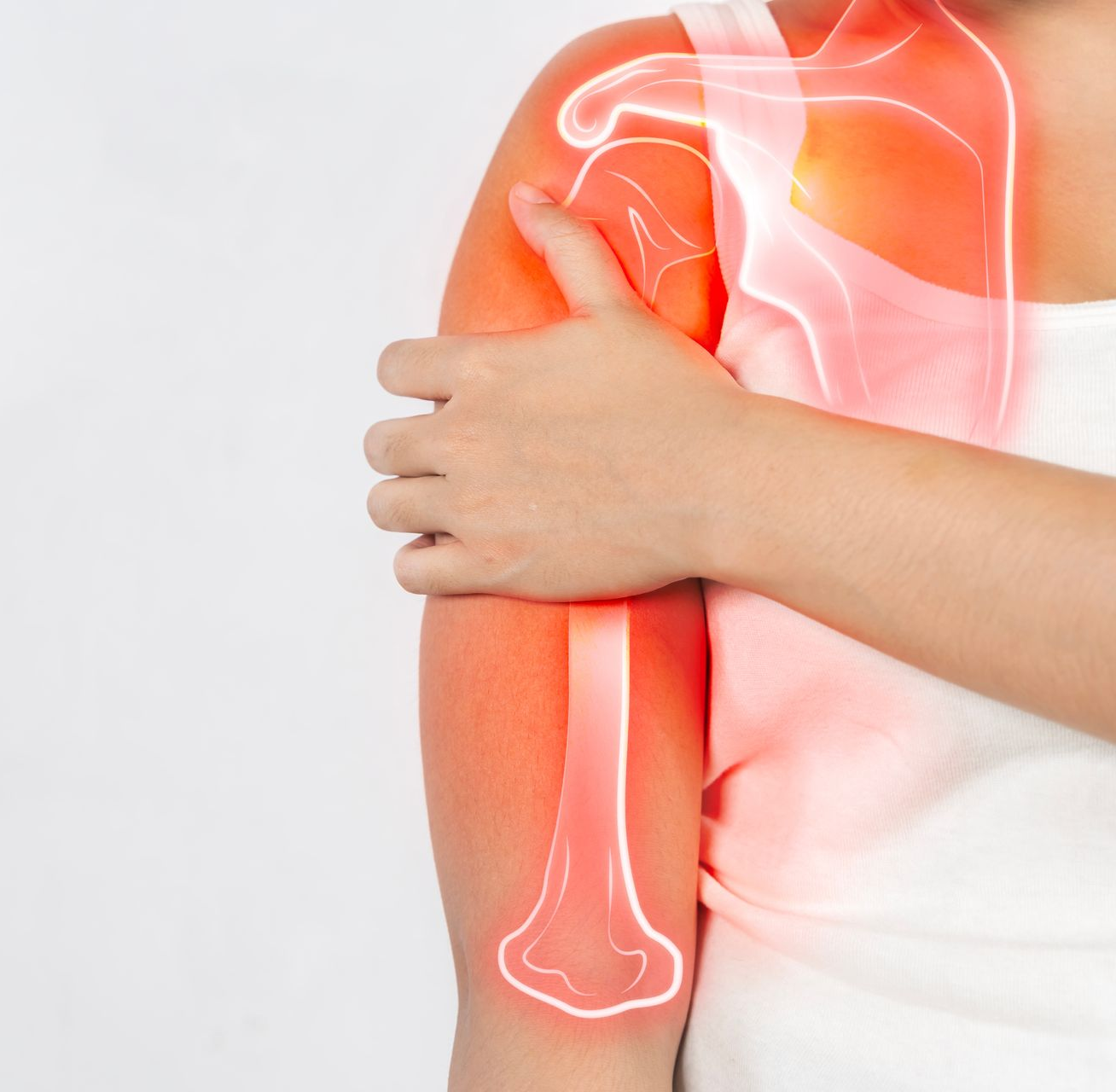 Person holding upper arm with red pain overlay on shoulder and arm skeleton graphic
