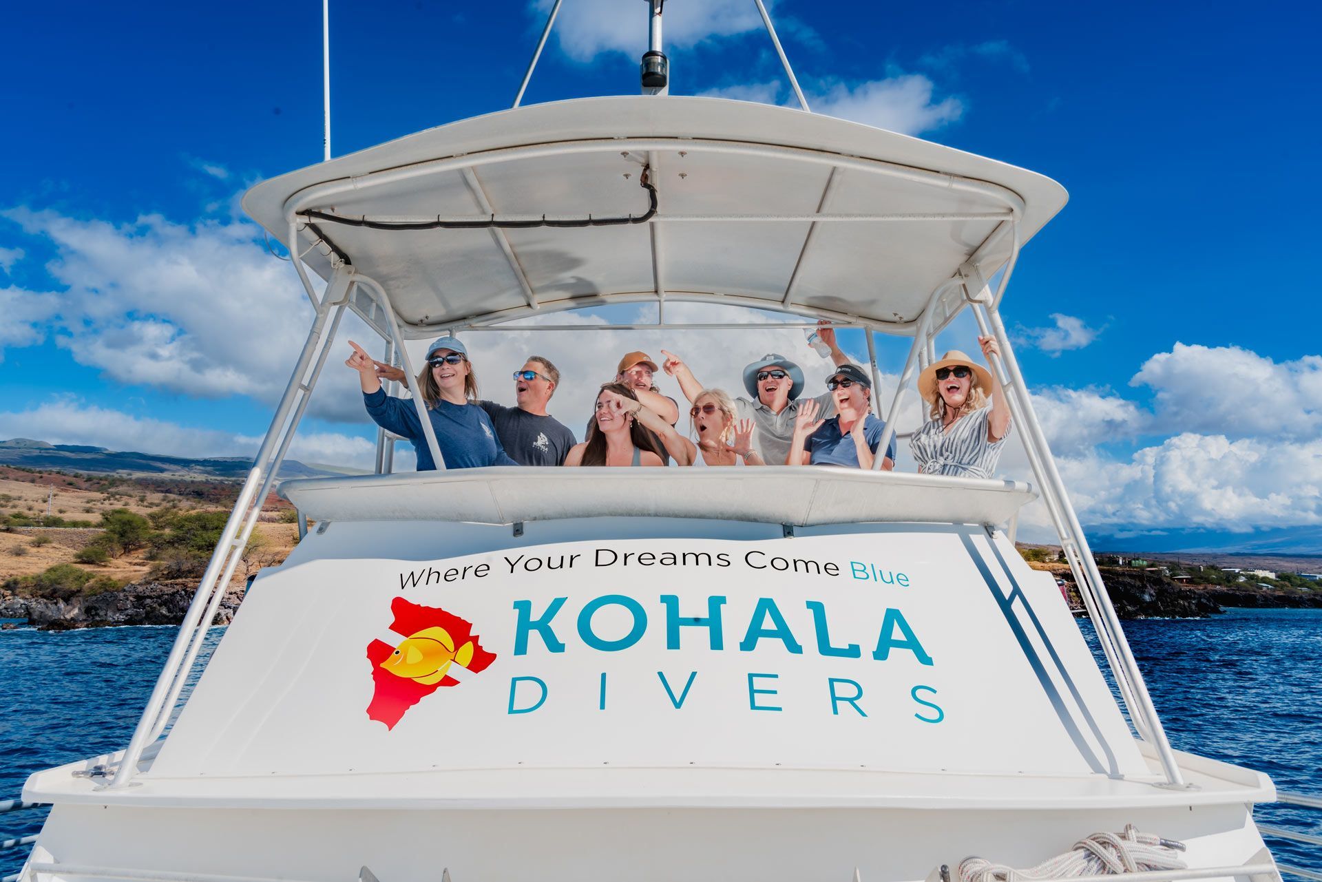 A group of people are sitting on the back of a boat.