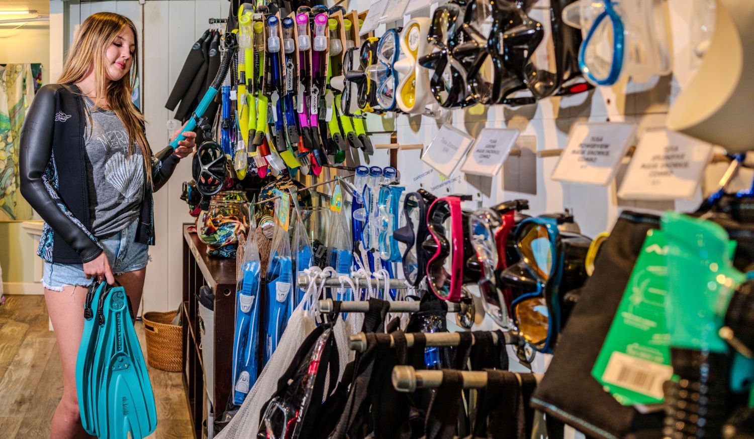 A woman is shopping for scuba gear in the dive shop