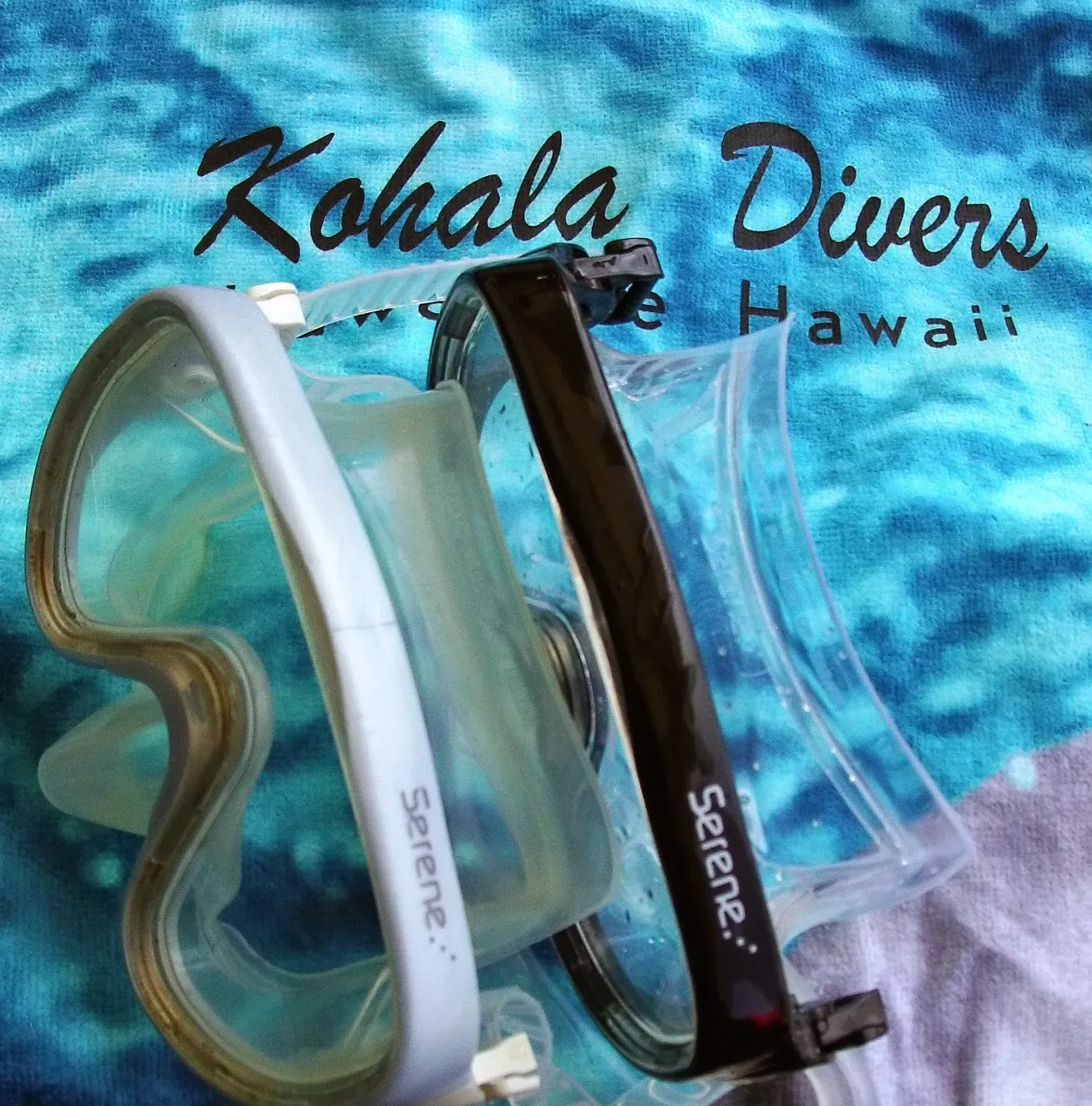 A pair of serene scuba diving goggles laying on a hawaiian towel
