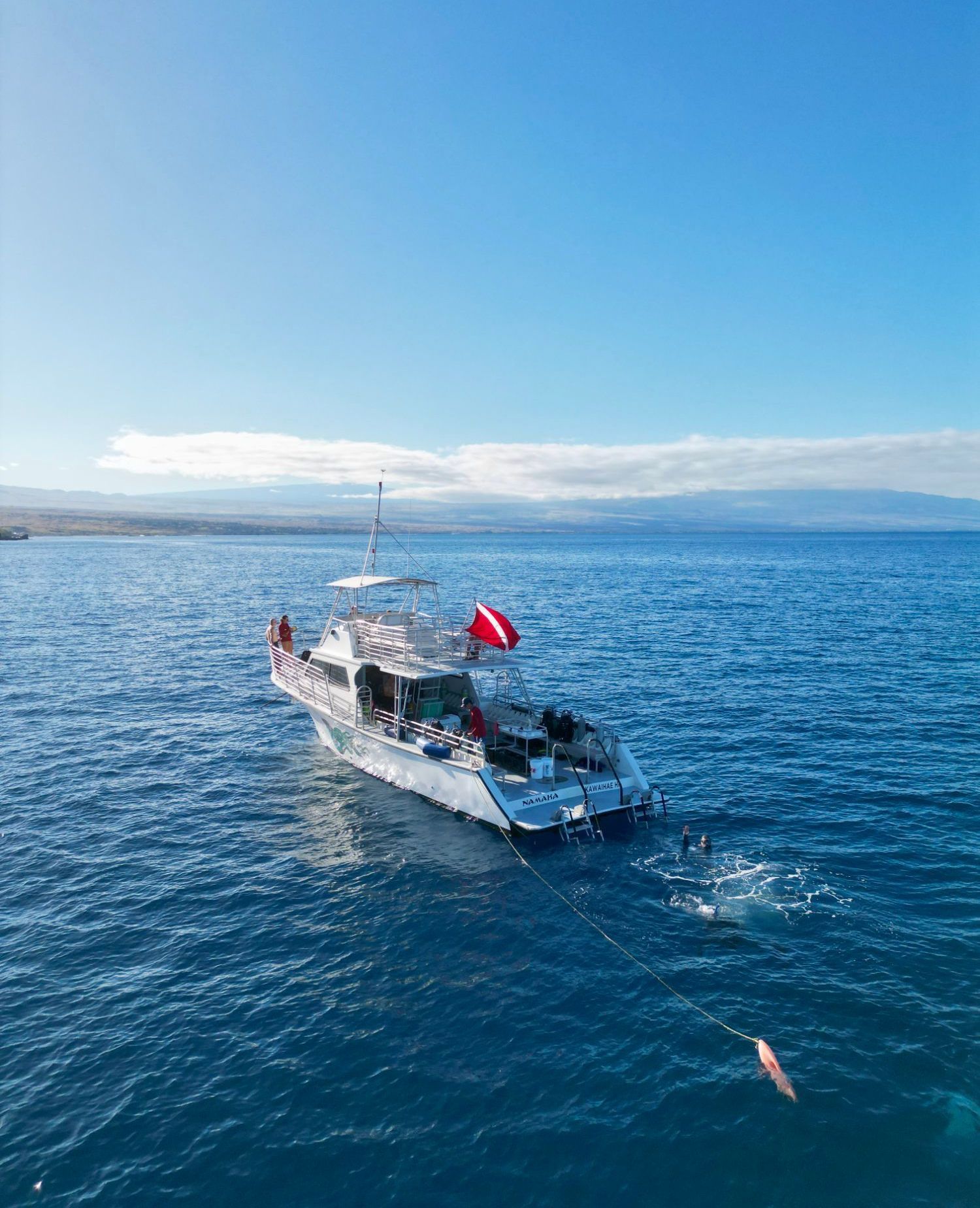 A boat is floating on top of a large body of water.
