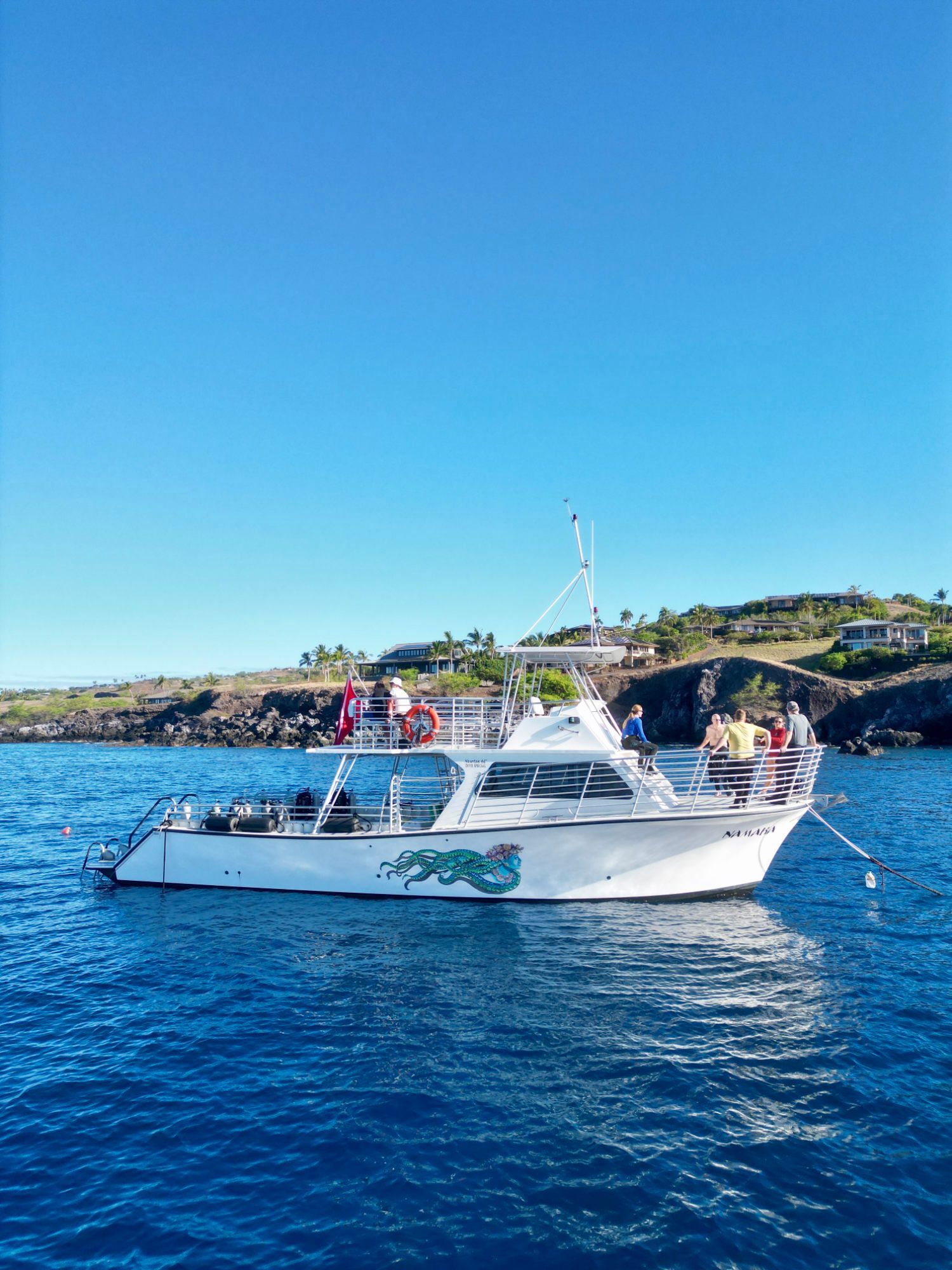 A large white boat is floating on top of a large body of water.