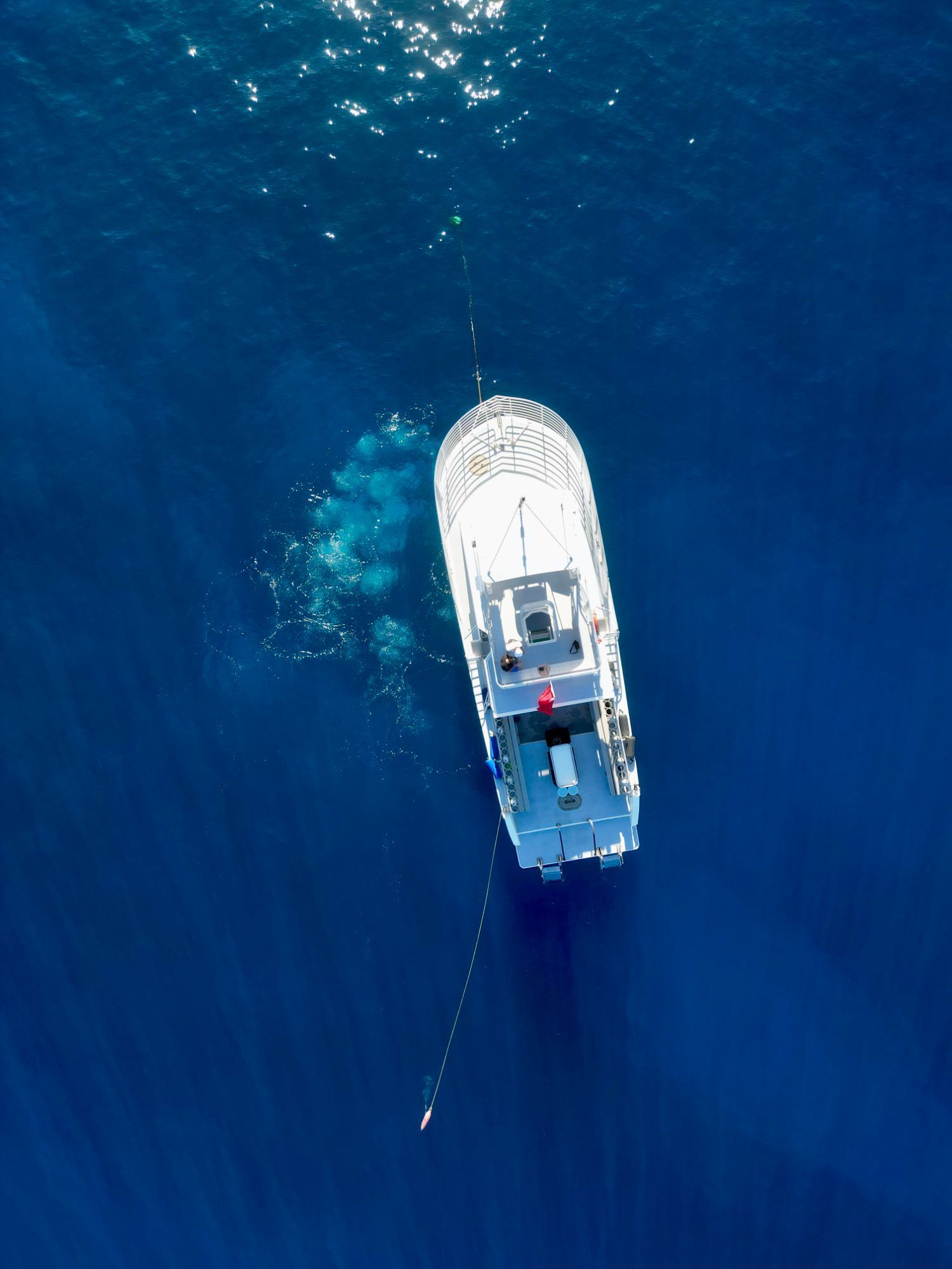 An aerial view of a boat in the ocean
