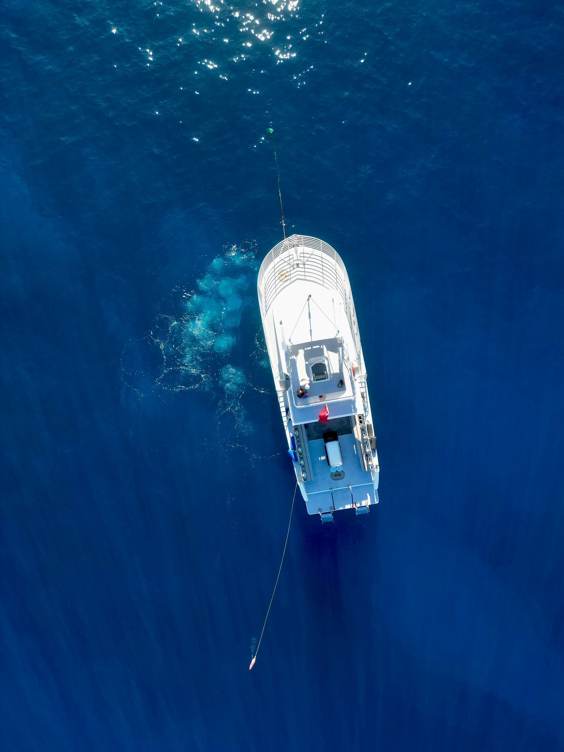 An aerial view of a boat in the ocean