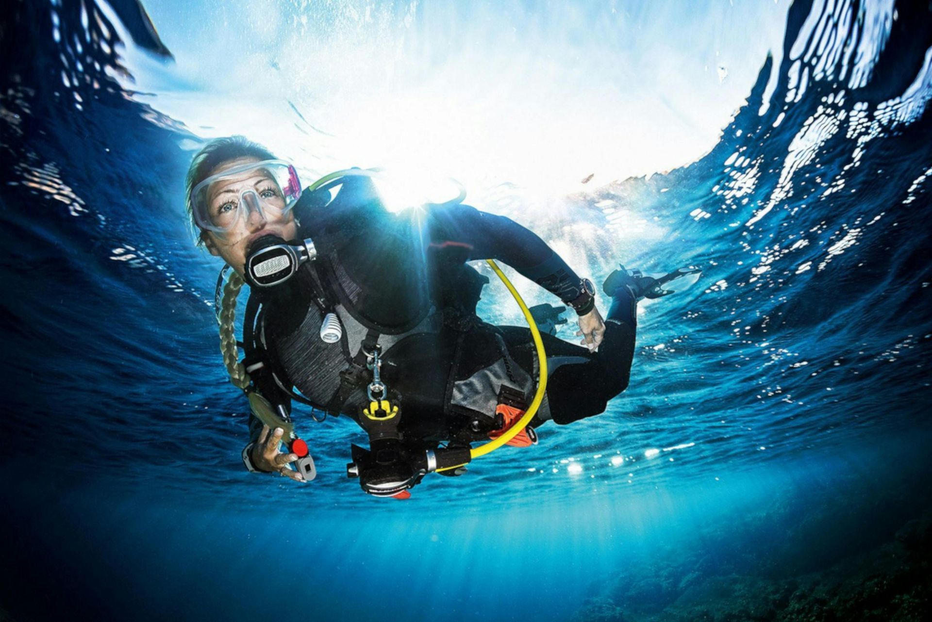 A scuba diver is swimming in the ocean.