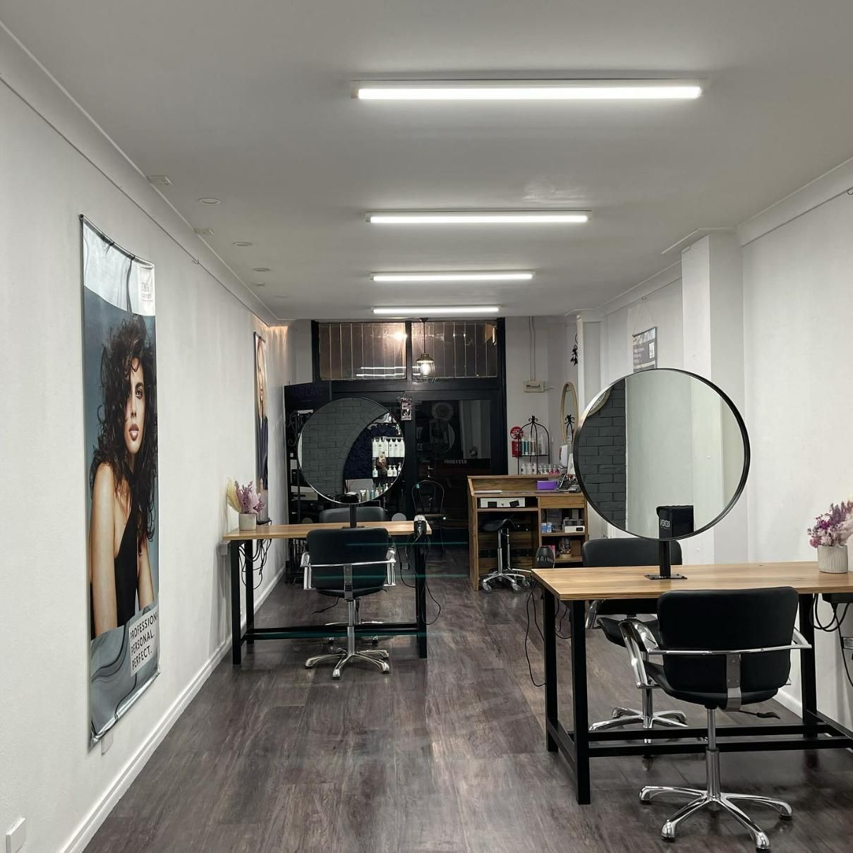 A Long Hallway with Tables and Chairs in A Hair Salon — Main Hair Design in Armidale, NSW