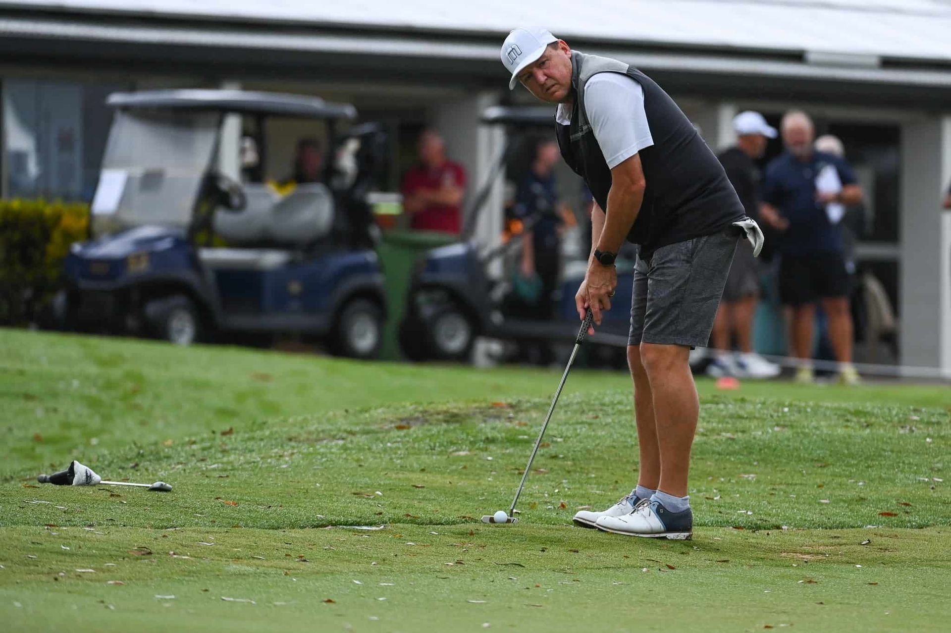 A Man Is Putting A Golf Ball On A Golf Course — Rowes Bay Golf Club In Rowes Bay, QLD