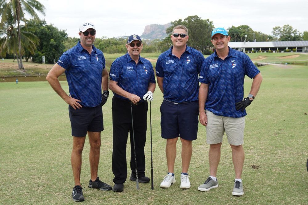 A group of men are standing on a golf course holding golf clubs— Rowes Bay Golf Club In Rowes Bay, QLD