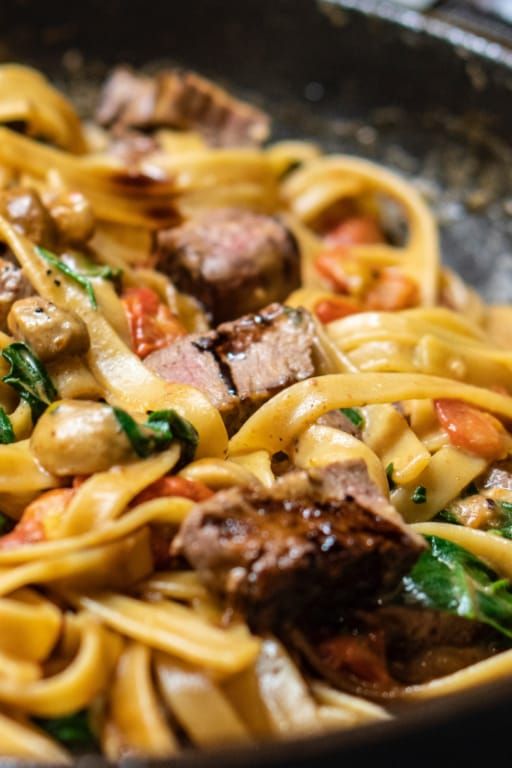 A close up of a pan of pasta with meat and vegetables.