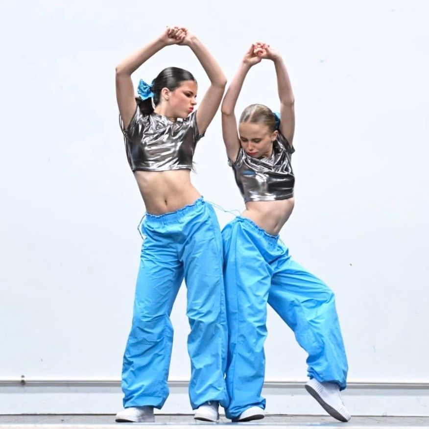 A group of young people are dancing on a stage