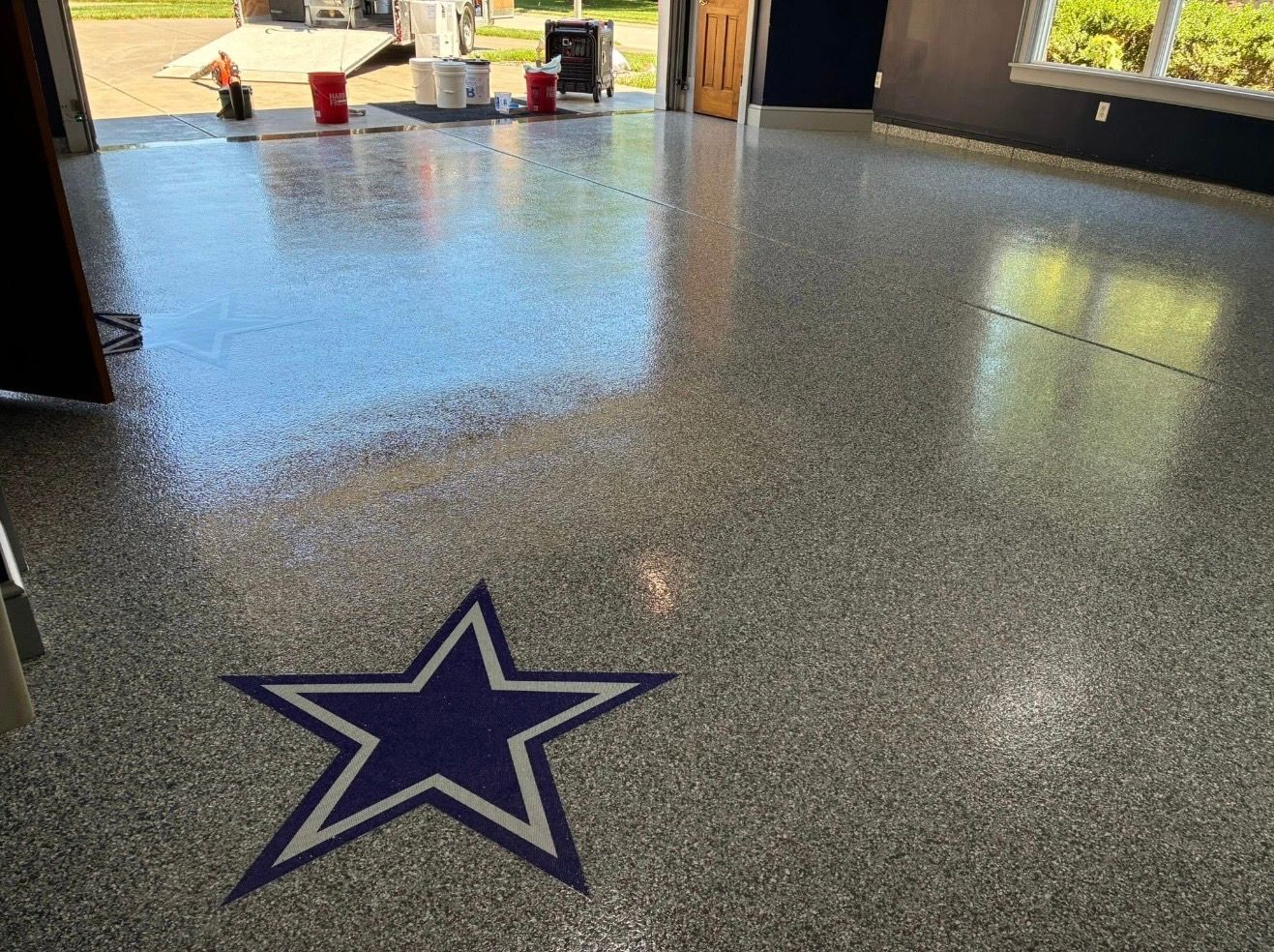 Polished speckled floor with a large blue star emblem in a hallway or lobby