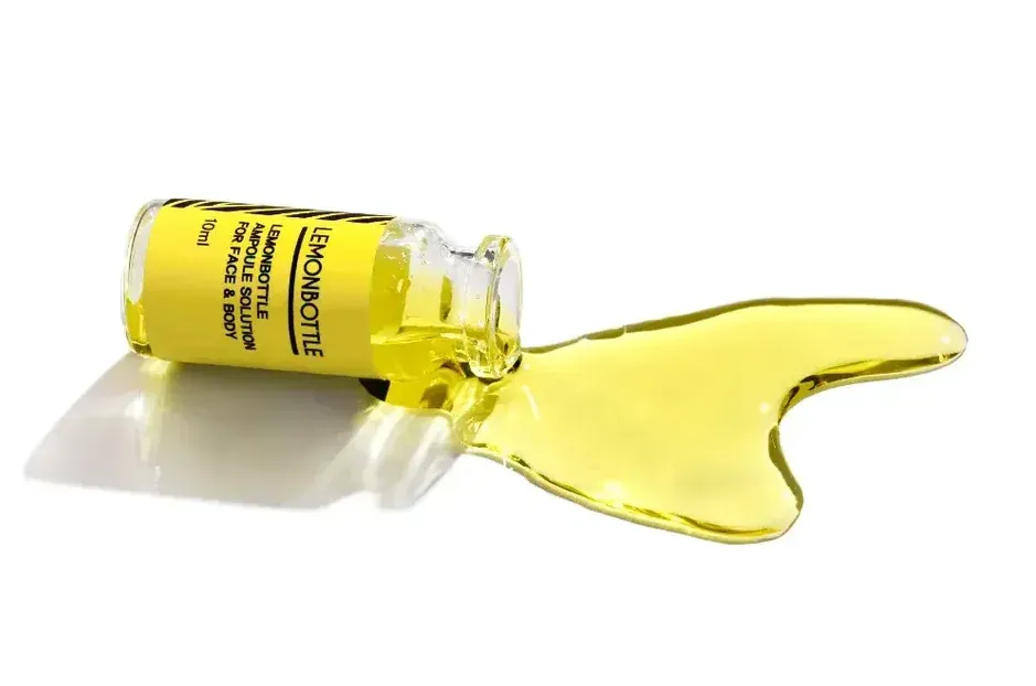 Gelbe Flüssigkeit ergießt sich aus einer umgekippten Flasche auf eine weiße Oberfläche