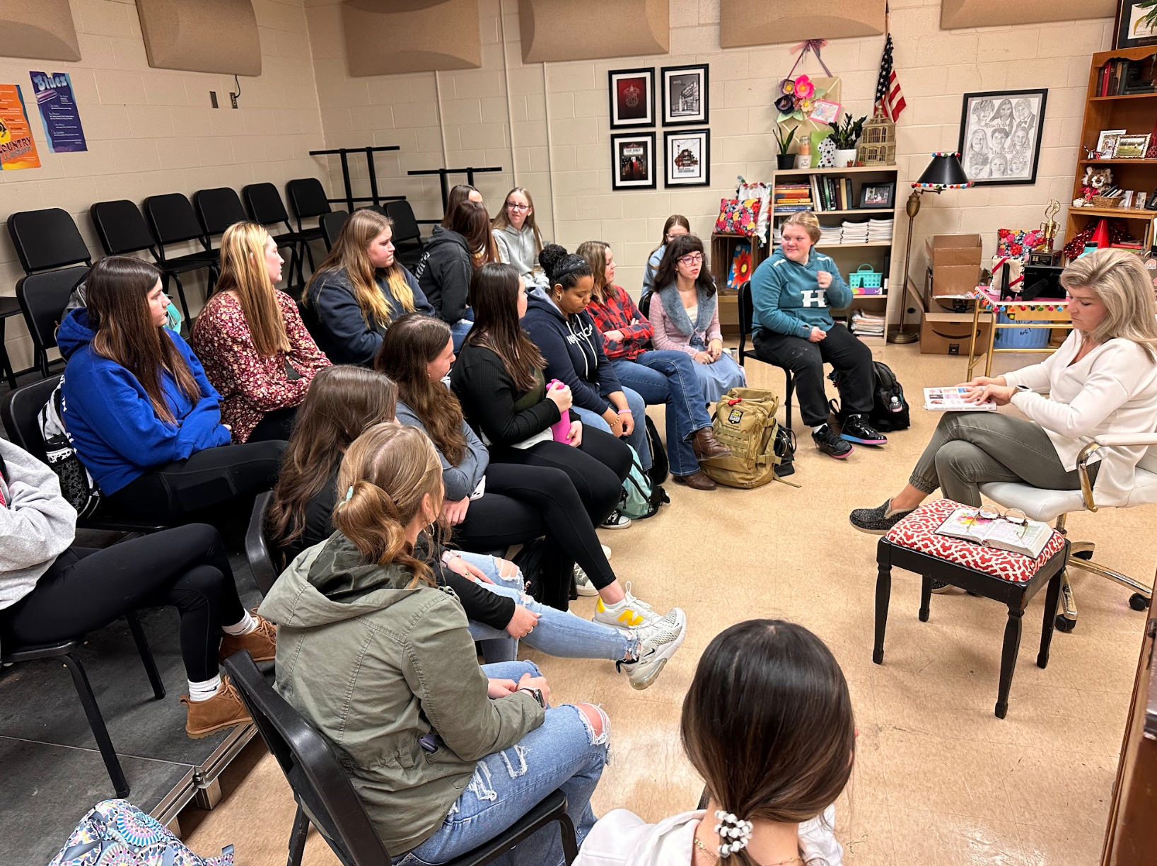A group of people are sitting in a circle in a room.