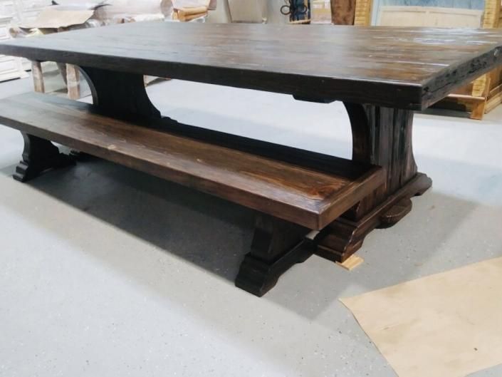 Rustic wooden dining table with a built-in bench in a room