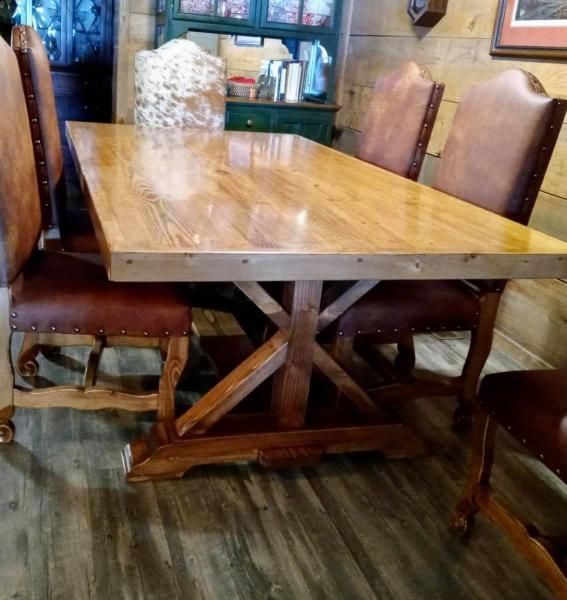Wooden dining table with leather chairs in a rustic restaurant setting