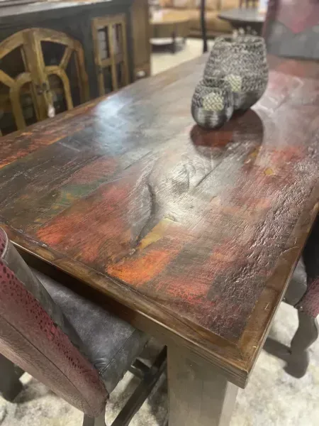Decorative bird figurine on a worn wooden table in a restaurant setting