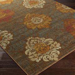 Brown floral patterned rug on a dark wood floor