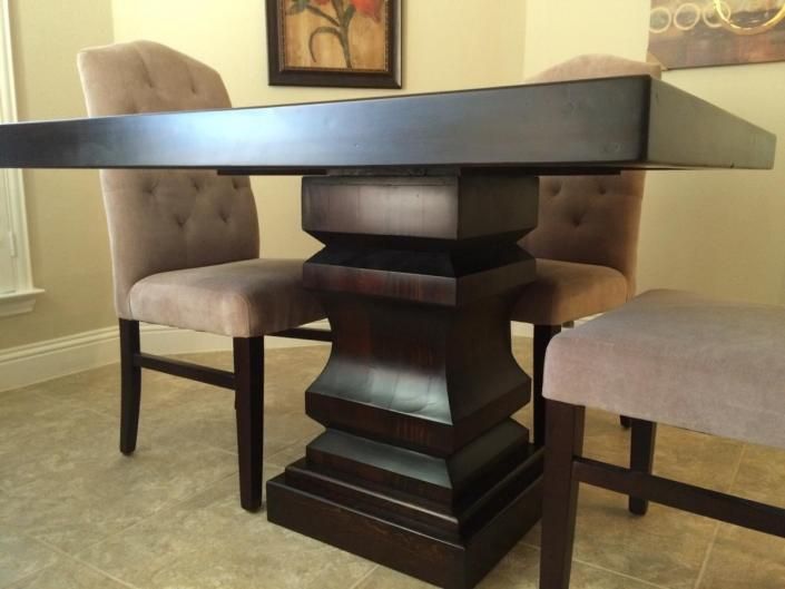 Dark wood dining table with upholstered chairs in a dining room